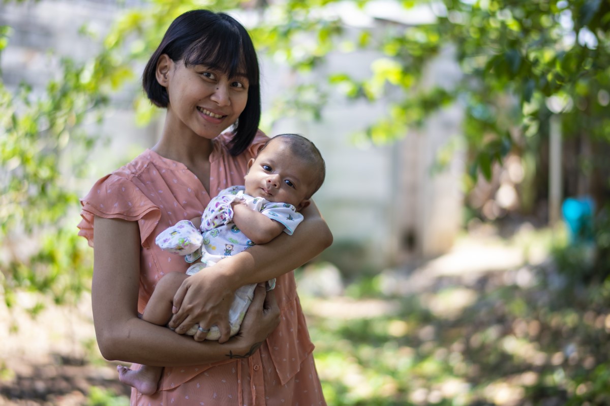 Mother and baby in Indonesia A woman holding a baby.