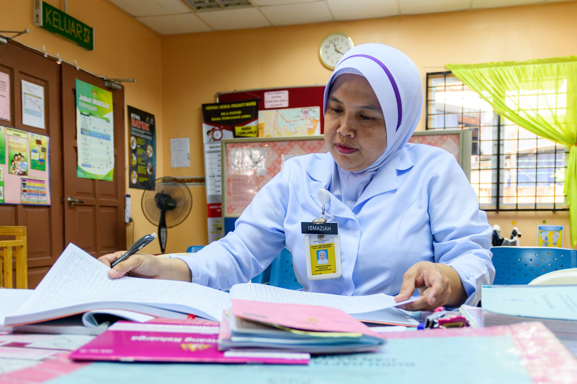 Nurse in Malaysia 1 Ismaziah, a community nurse and midwife, fills up her report on the mothers she has visited in the official county medical ledger.